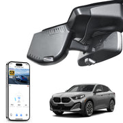 Car rearview mirror built-in dash cam with smartphone app control, 4K Ultra HD recording, GPS tracking, and BMW X2 Gen2 SUV models in the background.