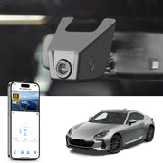 Car rearview mirror built-in dash cam with smartphone app control, 4K Ultra HD recording, GPS tracking, and Subaru BRZ Sports Car models in the background.