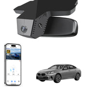 Car rearview mirror built-in dash cam with smartphone app control, 4K Ultra HD recording, GPS tracking, and BMW 2 Series M2 models in the background.