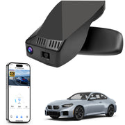 Car rearview mirror built-in dash cam with smartphone app control, 4K Ultra HD recording, GPS tracking, and BMW 2 Series M2 models in the background.